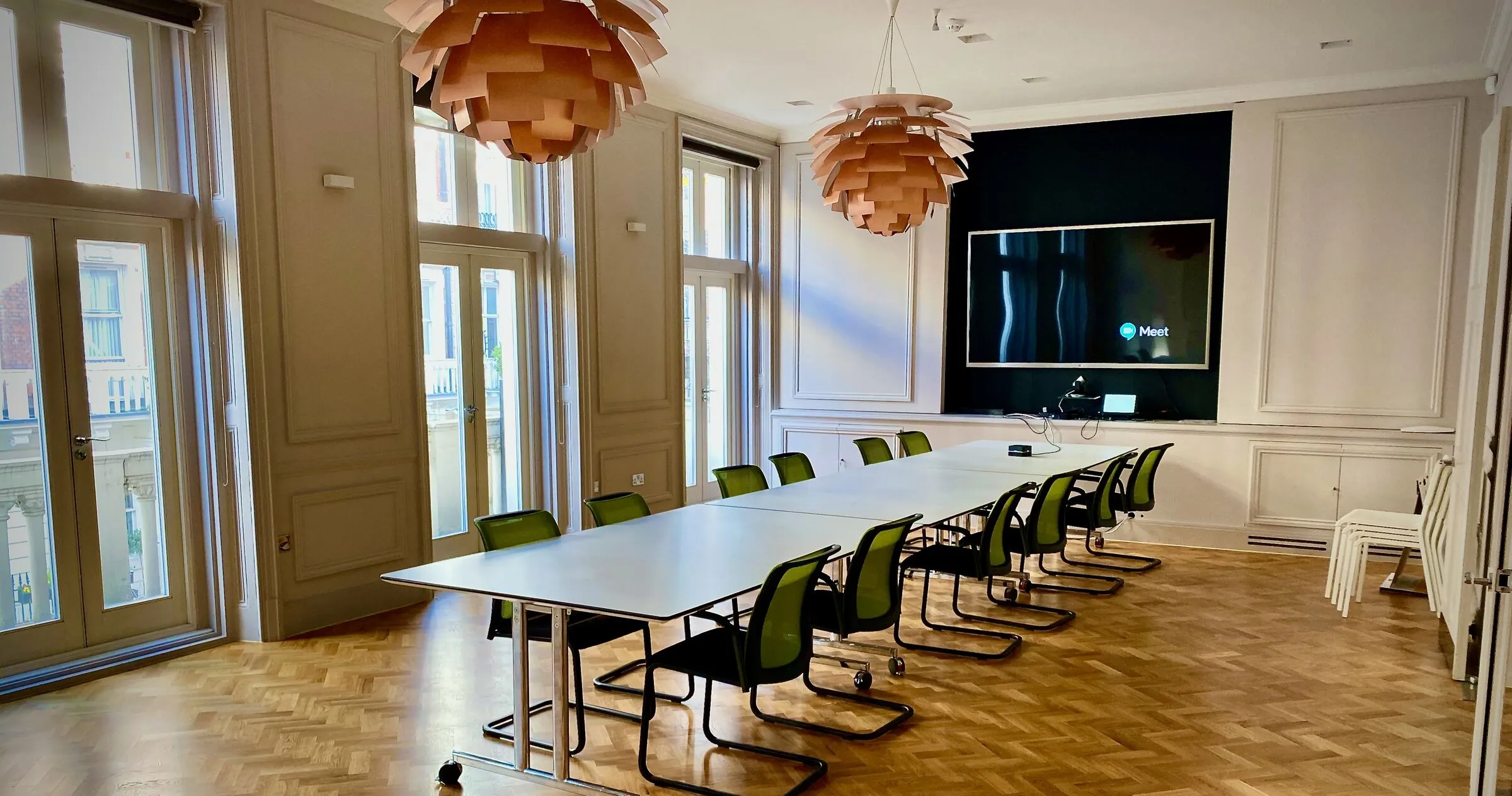 An empty board room, table set for a meeting